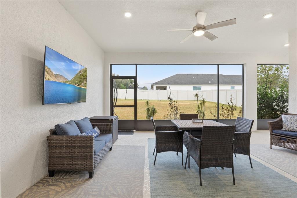 1271 Waterview Ridge Circle Apopka, FL 32703 - Photo 41 of 56 a dining room with furniture a rug and a floor to ceiling window