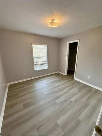 a bathroom with a granite countertop double vanity sink a toilet a mirror and shower