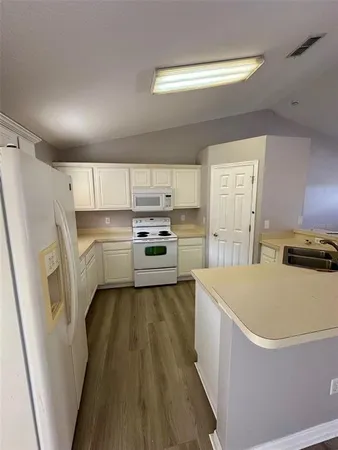 a kitchen with stainless steel appliances a refrigerator and a stove top oven