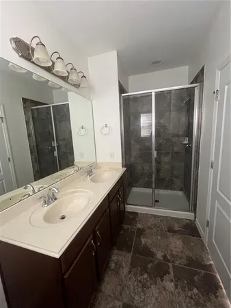 a bathroom with a sink a mirror and a shower