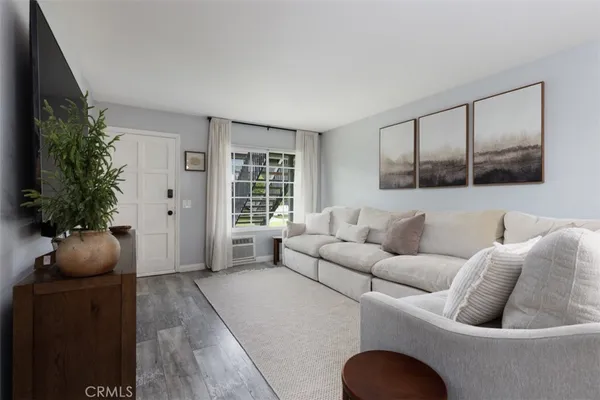 a living room with furniture potted plant and a window
