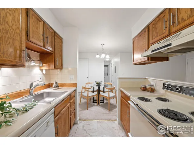 a kitchen with kitchen island granite countertop a sink a stove and cabinets