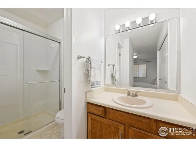 a bathroom with a sink shower vanity and a mirror