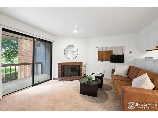 a living room with furniture a large window and a flat screen tv