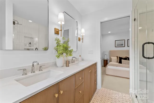 a en suite bathroom with a sink double vanity and a mirror