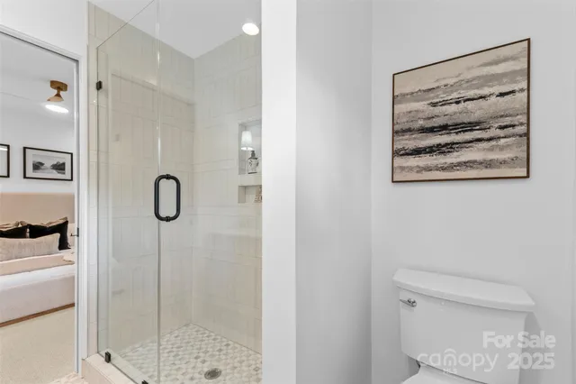 a bathroom with a shower toilet and sink