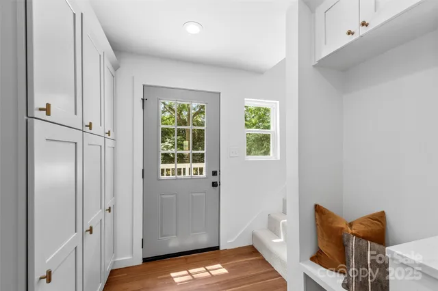 a view of a bedroom with furniture and window