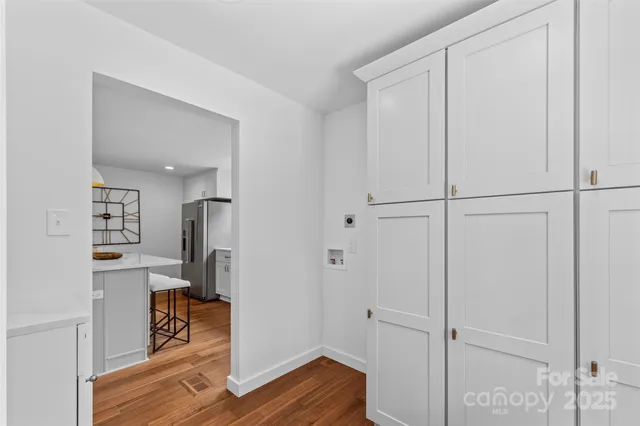 a view of a room with wooden floor
