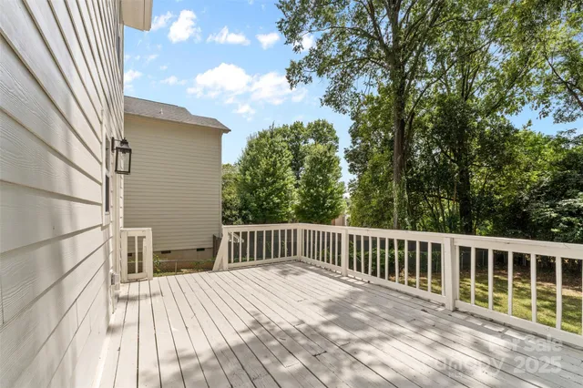 a balcony with wooden floor and fence