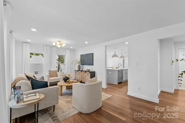 a living room with fireplace furniture and a wooden floor