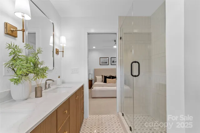 a bathroom with a sink a faucet a potted plant and a shower