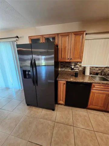 a large kitchen with cabinets and stainless steel appliances
