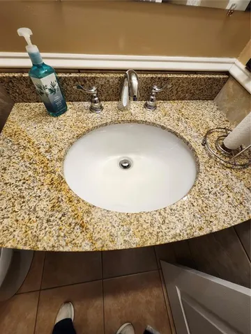 a spacious bathroom with a bathtub shower sink mirror and toilet