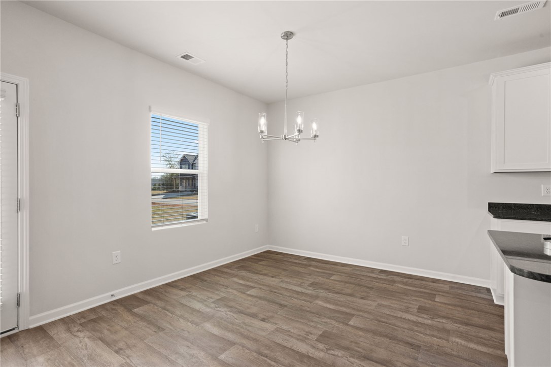 629 Silver Fir Street Piedmont, SC 29673 - Photo 14 of 36 This bright dining area features elegant flooring and a modern light fixture.