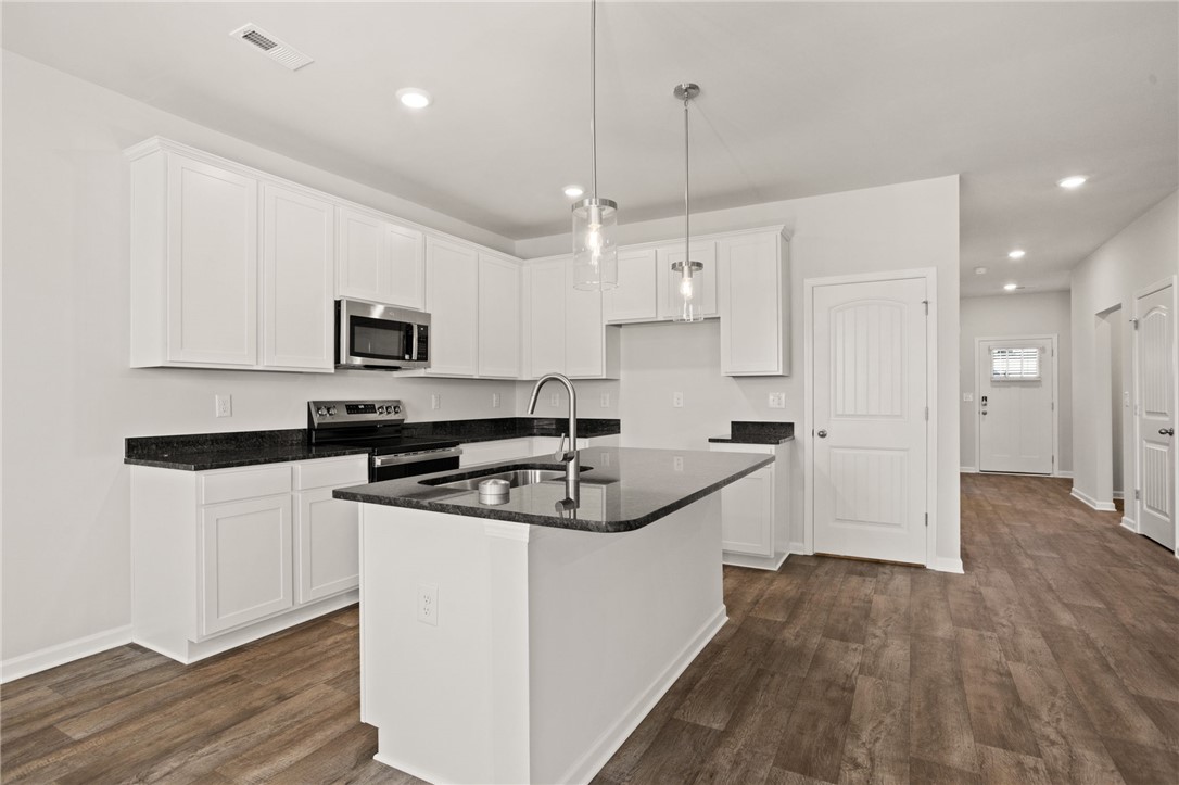 629 Silver Fir Street Piedmont, SC 29673 - Photo 16 of 36 This bright kitchen features sleek white cabinetry and a convenient island with ample counter space.