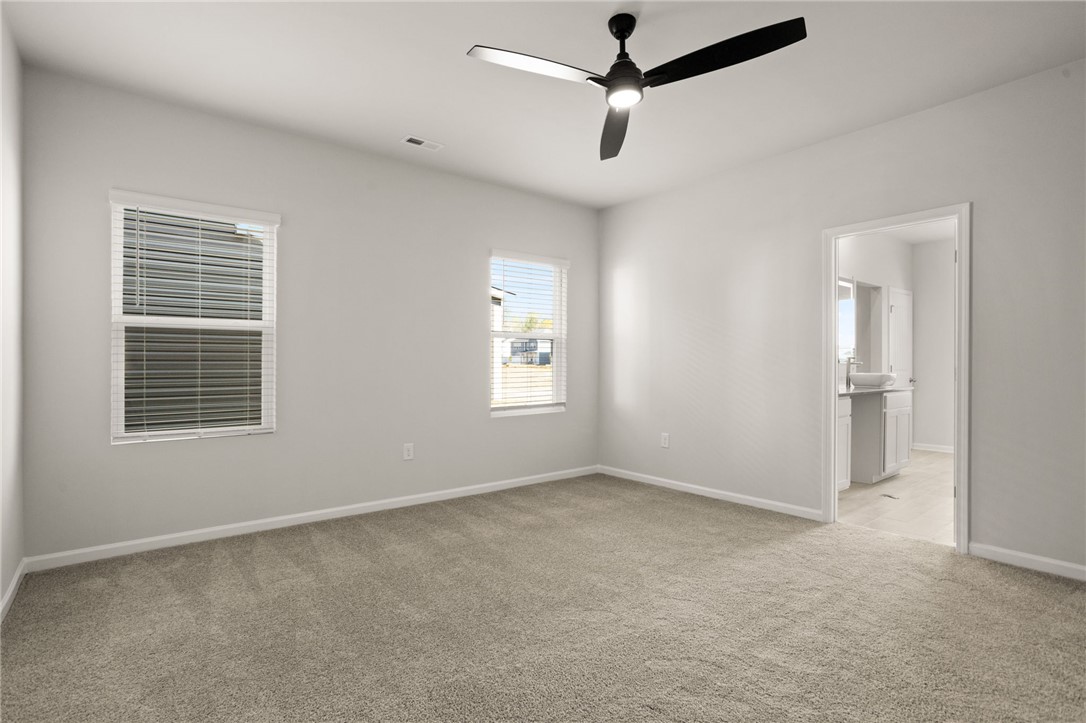 629 Silver Fir Street Piedmont, SC 29673 - Photo 18 of 36 This spacious bedroom offers ample natural light and direct access to a private bathroom.