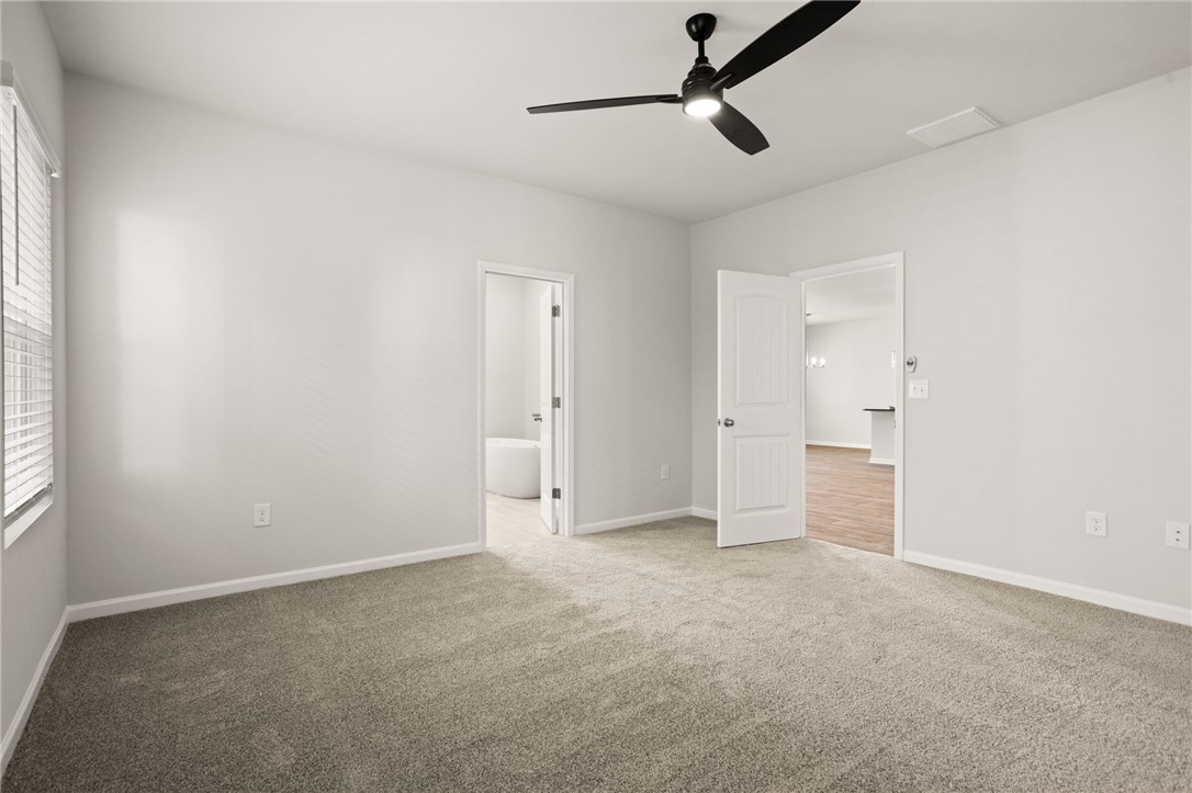 629 Silver Fir Street Piedmont, SC 29673 - Photo 19 of 36 This spacious bedroom offers ample natural light and a comforting atmosphere.