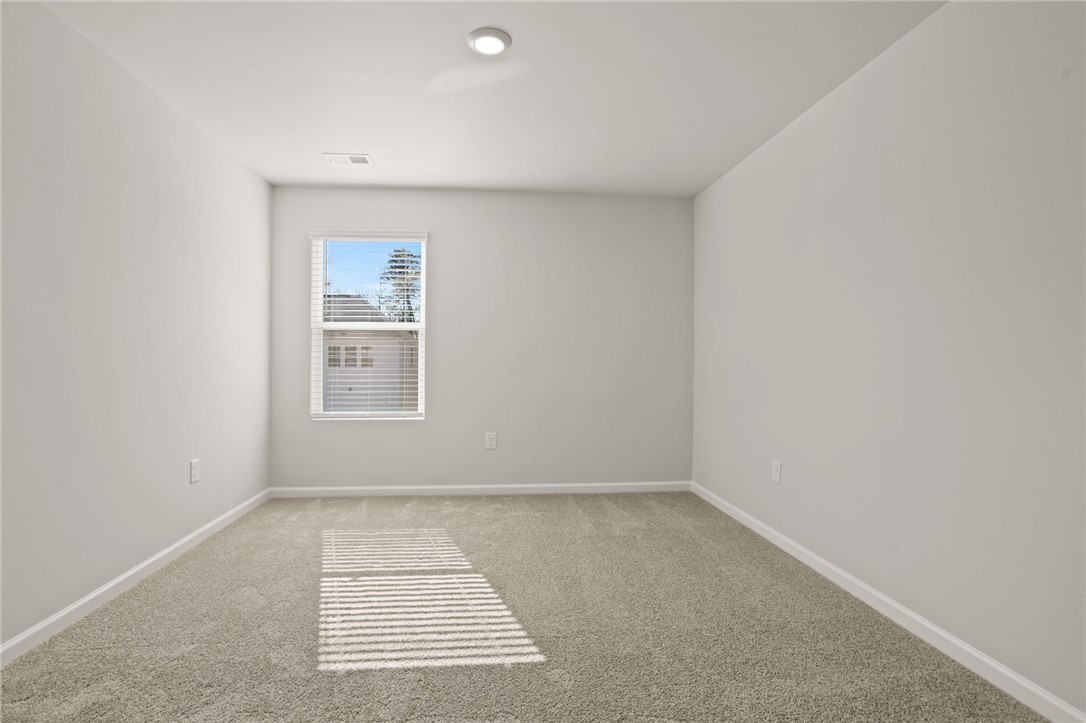 629 Silver Fir Street Piedmont, SC 29673 - Photo 27 of 36 This airy room offers comfort and potential, featuring soft carpeting and ample natural light.