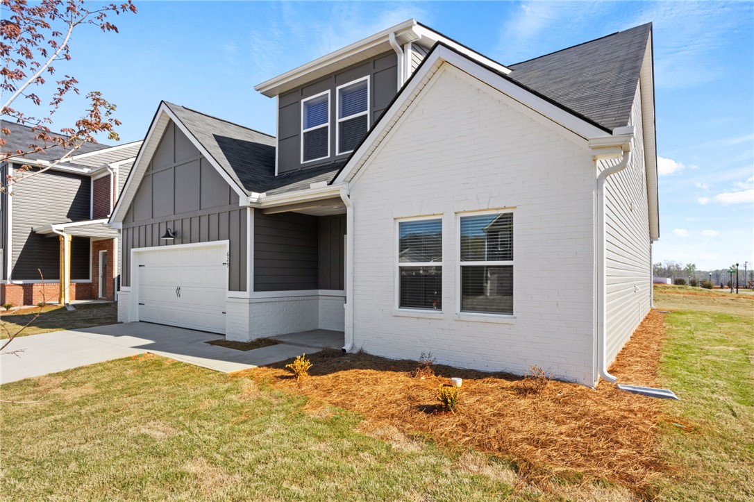 629 Silver Fir Street Piedmont, SC 29673 - Photo 3 of 36 This modern residence showcases a blend of textures, featuring brick and board and batten siding.