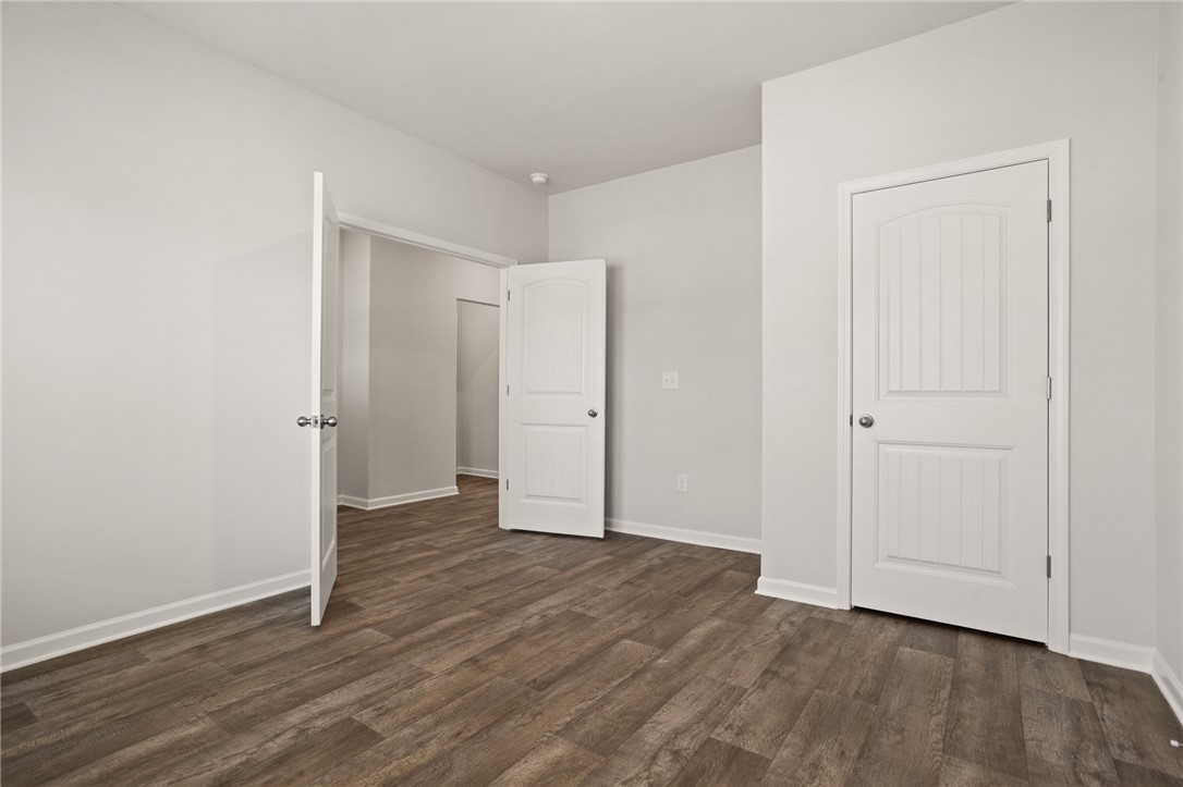 629 Silver Fir Street Piedmont, SC 29673 - Photo 7 of 36 This bright, empty room offers wood flooring and white doors, ready for personalized touches.