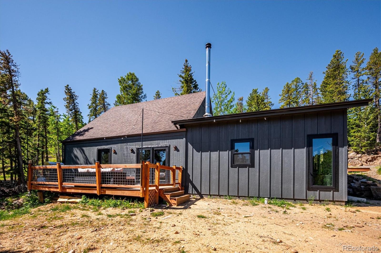 1633 Sinton Road Evergreen, CO 80439 - Photo 19 of 50 a view of a house with a wooden fence