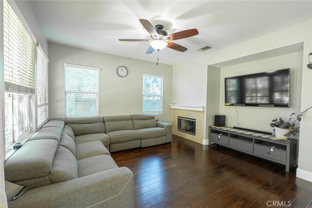 40601 Cebu Street Temecula, CA 92591 - Photo 12 of 26 a living room with furniture flat screen tv and wooden floor