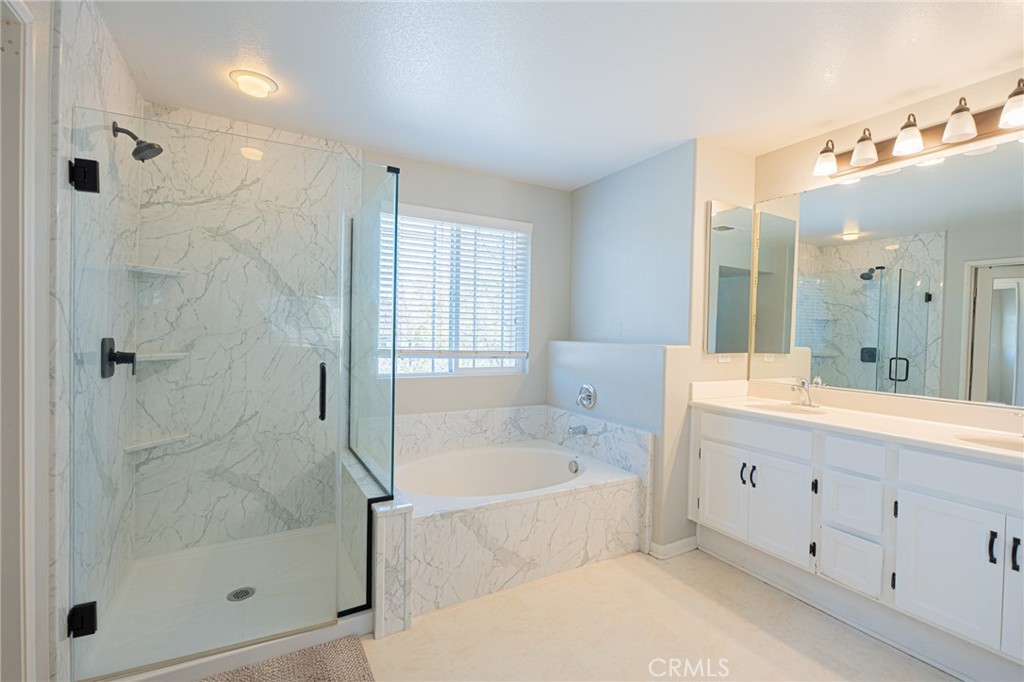 40601 Cebu Street Temecula, CA 92591 - Photo 16 of 26 a large spacious bathroom with a bathtub shower and sink