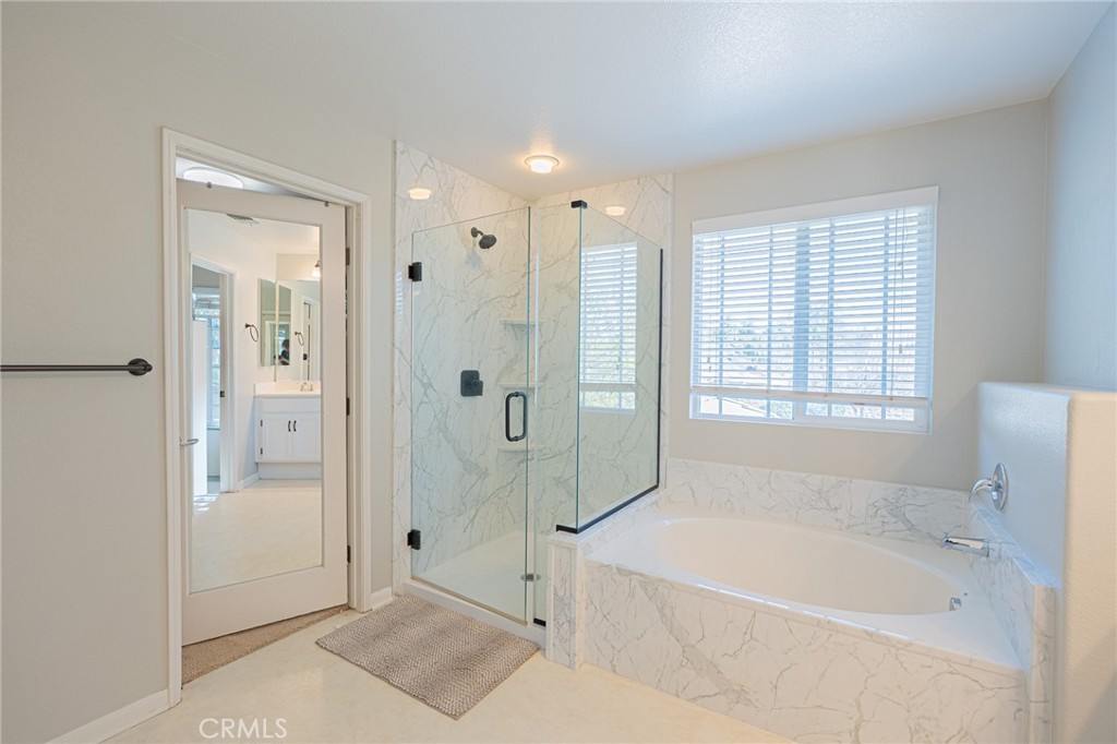 40601 Cebu Street Temecula, CA 92591 - Photo 17 of 26 a bathroom with a bathtub shower and toilet