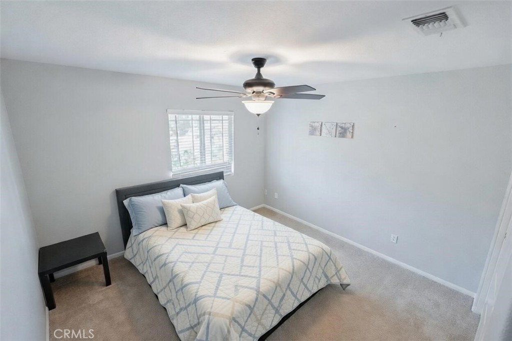 40601 Cebu Street Temecula, CA 92591 - Photo 19 of 26 a bedroom with a bed and a chandelier