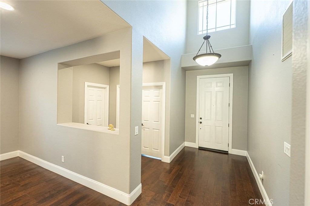 40601 Cebu Street Temecula, CA 92591 - Photo 25 of 26 an empty room with wooden floor and windows