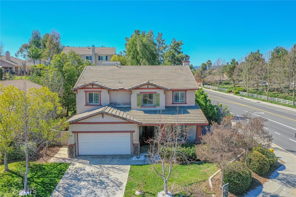 40601 Cebu Street Temecula, CA 92591 - Photo 3 of 26 a front view of a house with a yard and garage