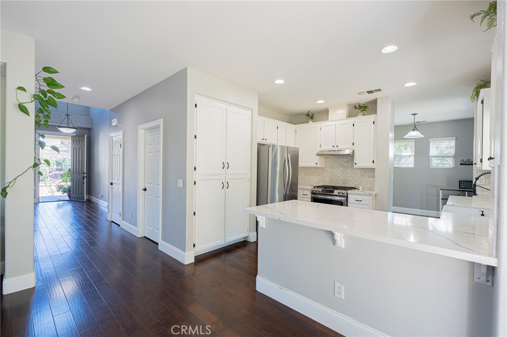 40601 Cebu Street Temecula, CA 92591 - Photo 9 of 26 a kitchen with stainless steel appliances a refrigerator sink and wooden floor