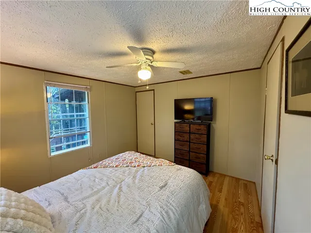 a bedroom with a bed and a chandelier