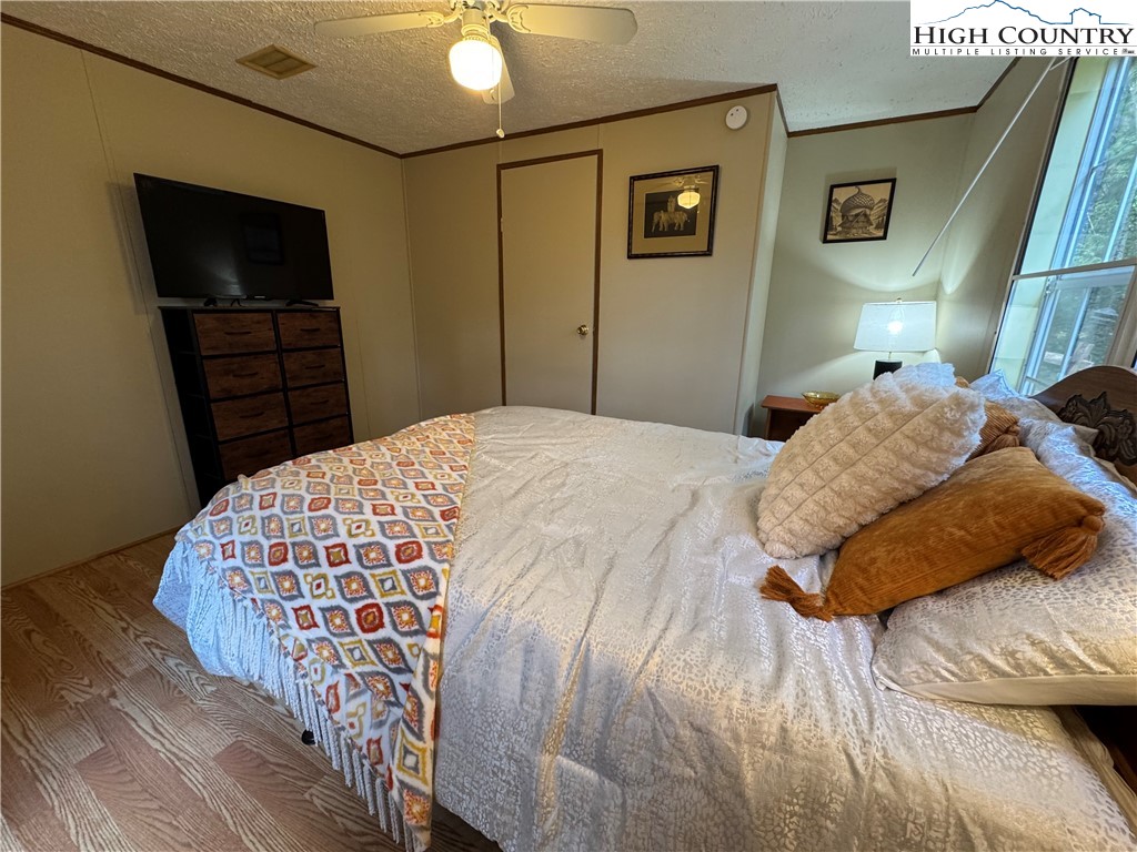 496 Laurelwood Lane Boone, NC 28607 - Photo 12 of 45 a bedroom with a bed and a flat screen tv