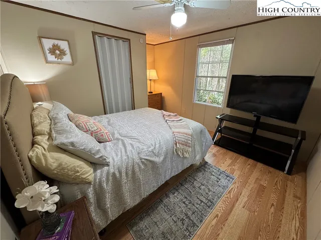 a bedroom with a bed and flat screen tv