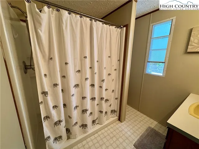 a bathroom with a shower curtain and sink