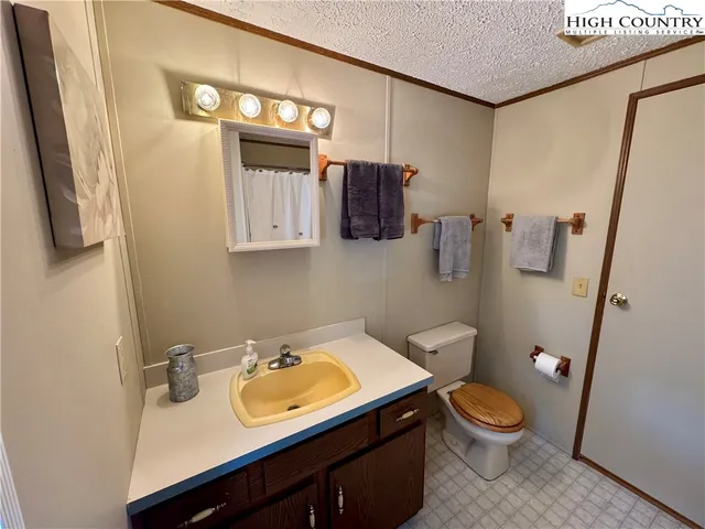 a bathroom with a sink a toilet and mirror