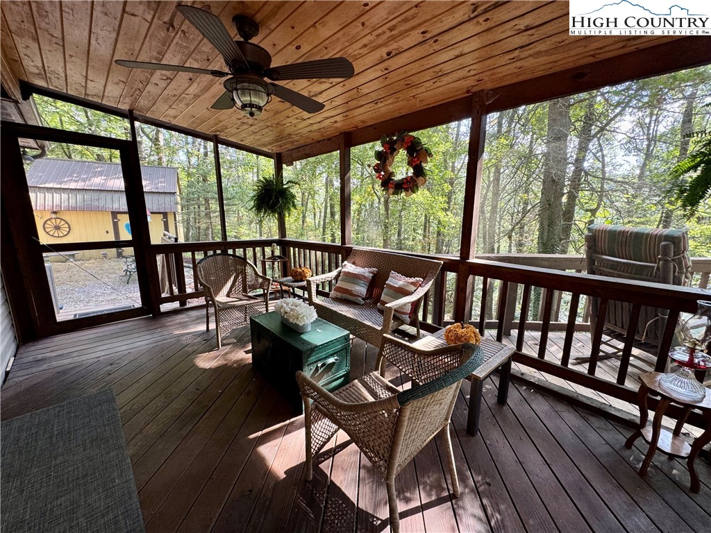 496 Laurelwood Lane Boone, NC 28607 - Photo 2 of 45 a view of a balcony with furniture and wooden floor