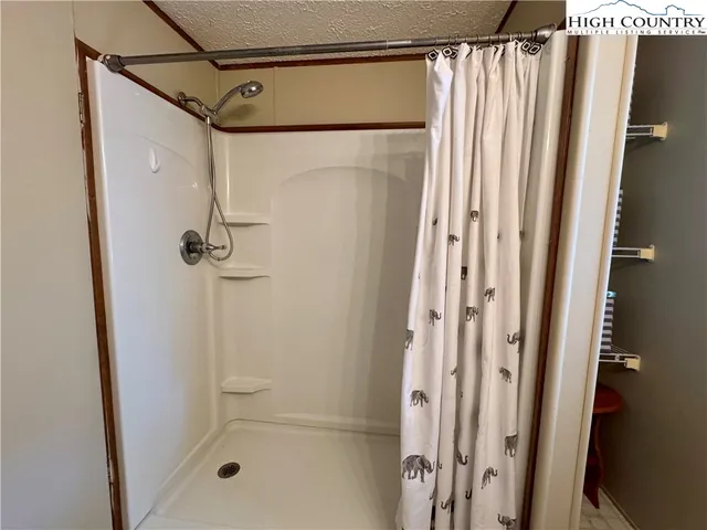 a bathroom with a shower and a glass door
