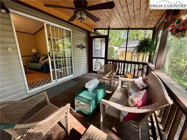 an outdoor view of a house with wooden floor outdoor seating