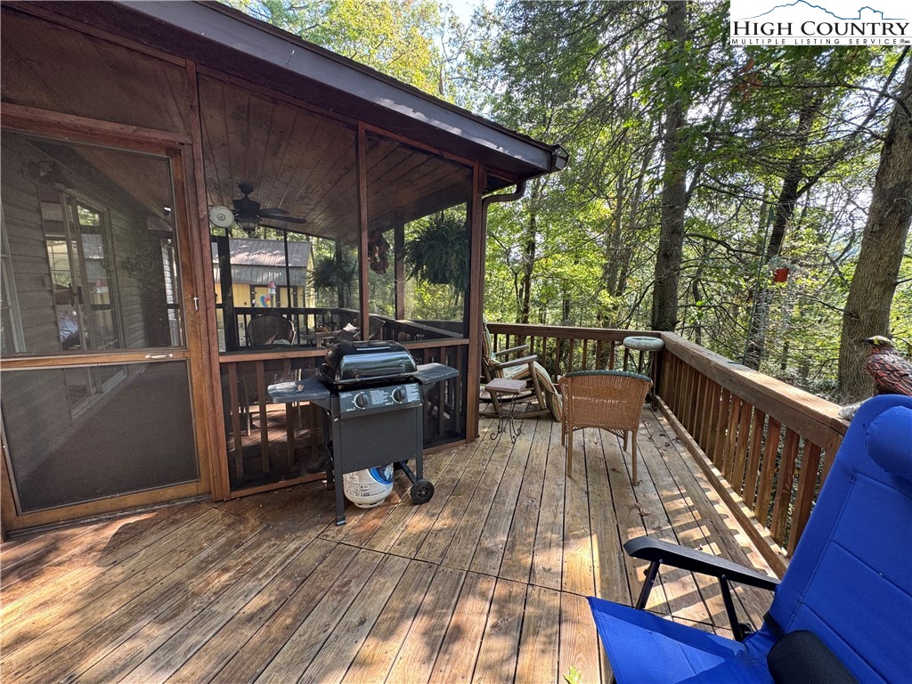 496 Laurelwood Lane Boone, NC 28607 - Photo 25 of 45 a view of a patio with lawn chairs under an umbrella