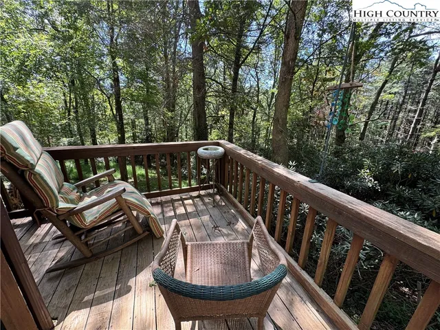 a view of a chair and table in the roof deck
