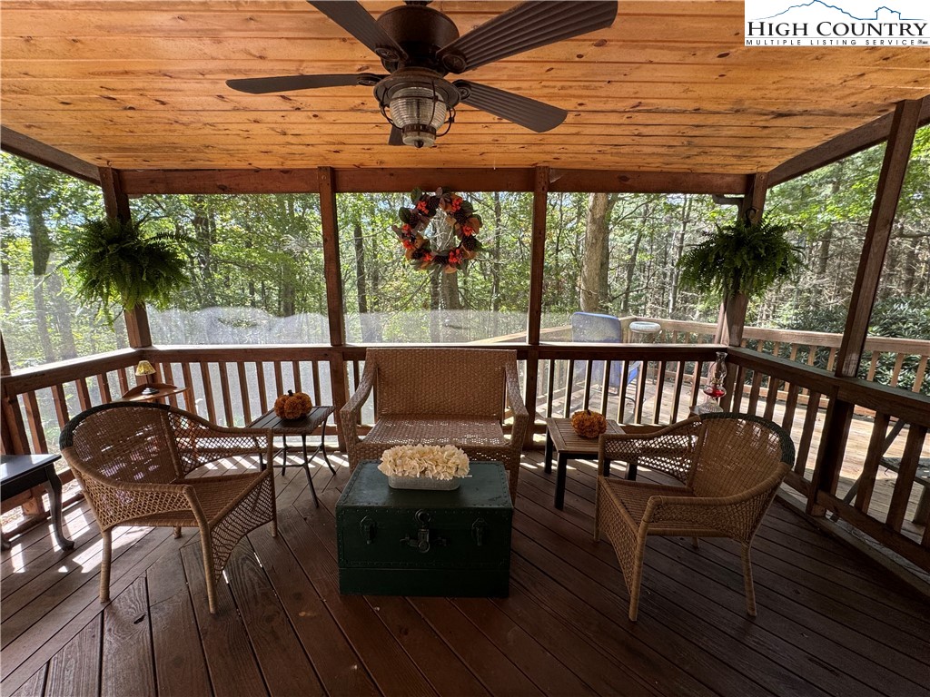 496 Laurelwood Lane Boone, NC 28607 - Photo 3 of 45 a view of a balcony with furniture and wooden floor