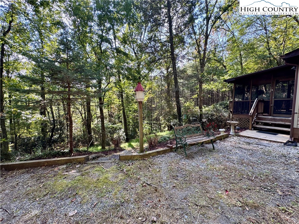 496 Laurelwood Lane Boone, NC 28607 - Photo 31 of 45 a view of backyard with wooden fence and a large tree