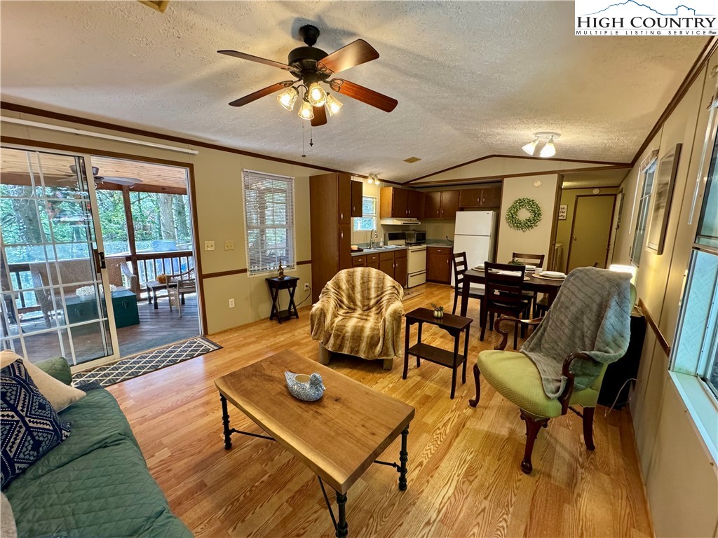 496 Laurelwood Lane Boone, NC 28607 - Photo 4 of 45 a living room with furniture a ceiling fan and a rug