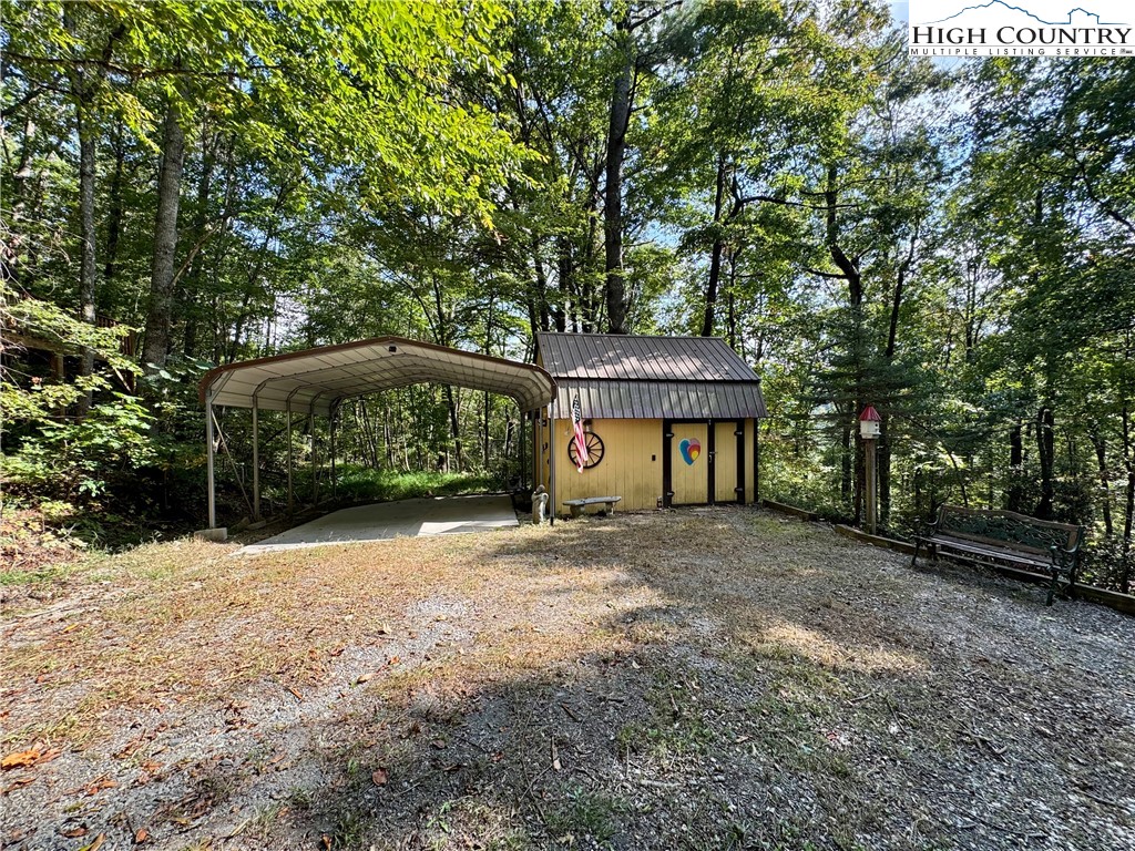 496 Laurelwood Lane Boone, NC 28607 - Photo 42 of 45 a front view of a house with a yard and garage