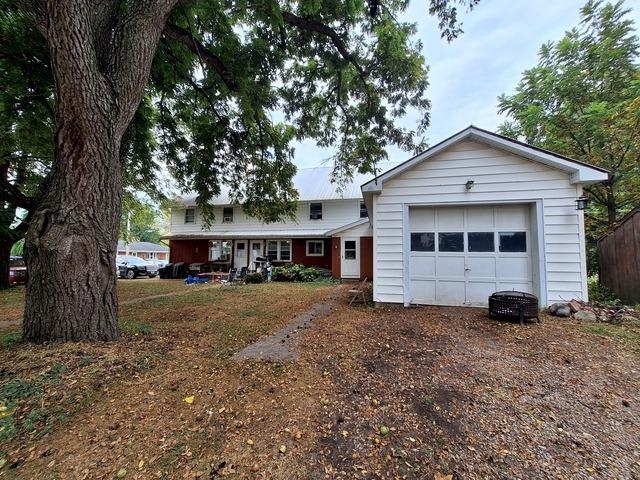 200 Oregon Street Troy Grove, IL 61372 - Photo 2 of 34 a front view of a house with a garden