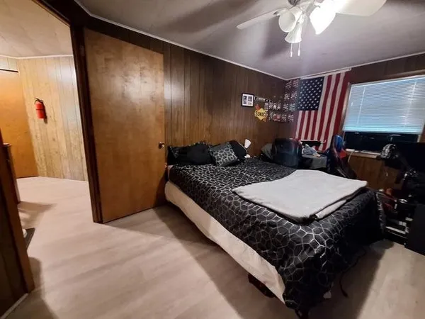 a bedroom with a bed and a chandelier