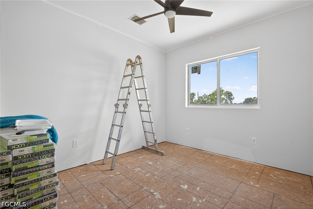 2665 Oil Well Road Naples, FL 34120 - Photo 23 of 40 wooden floor in an empty room with a window