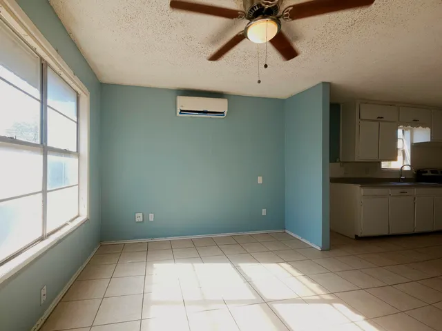 a view of room with window and ceiling fan